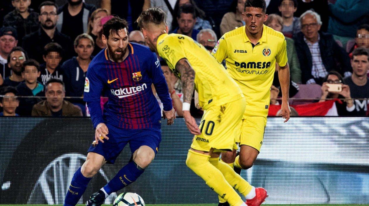 Lionel Messi enfrenta a dos jugadores del Villarreal. 