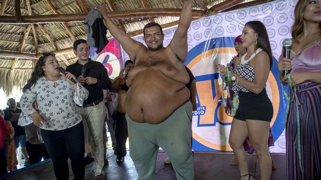 Rolando Javier Mena Salablanca (c), de 44 años, celebra luego de ganar el concurso "Papá Panzón" este viernes en Managua (Nicaragua). 