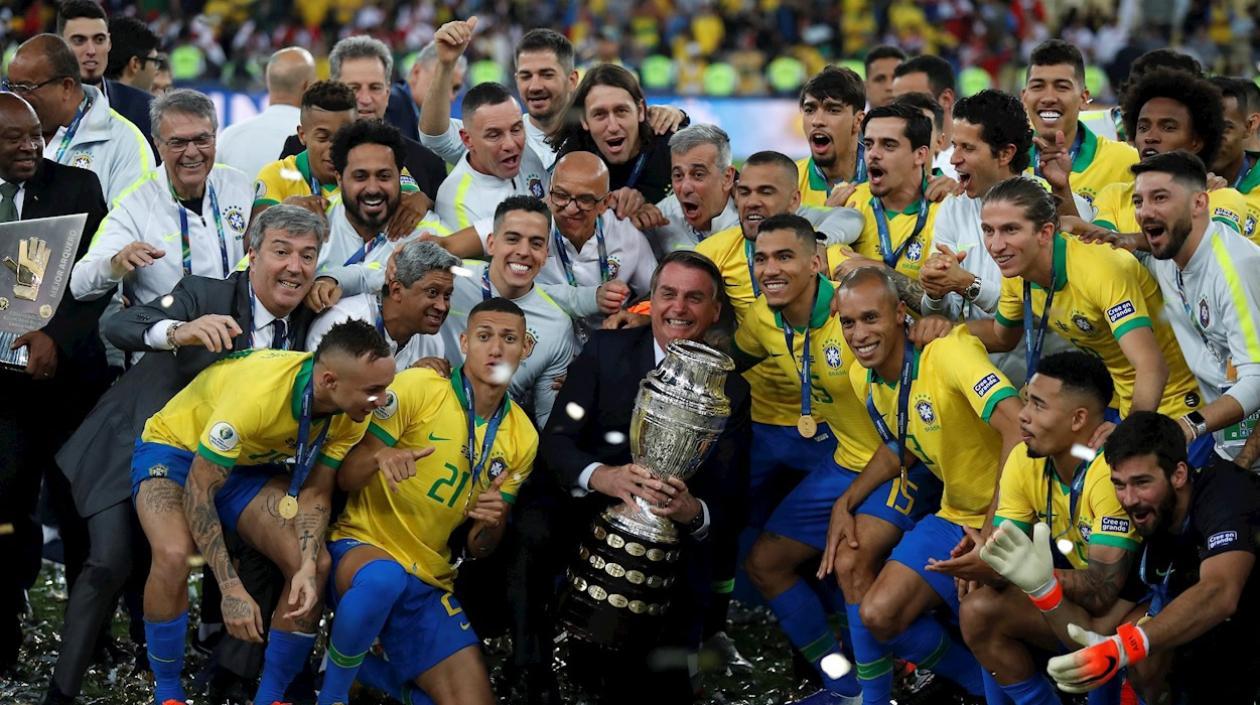 El presidente de Brasil Jair Bolsonaro (c) y jugadores de Brasil