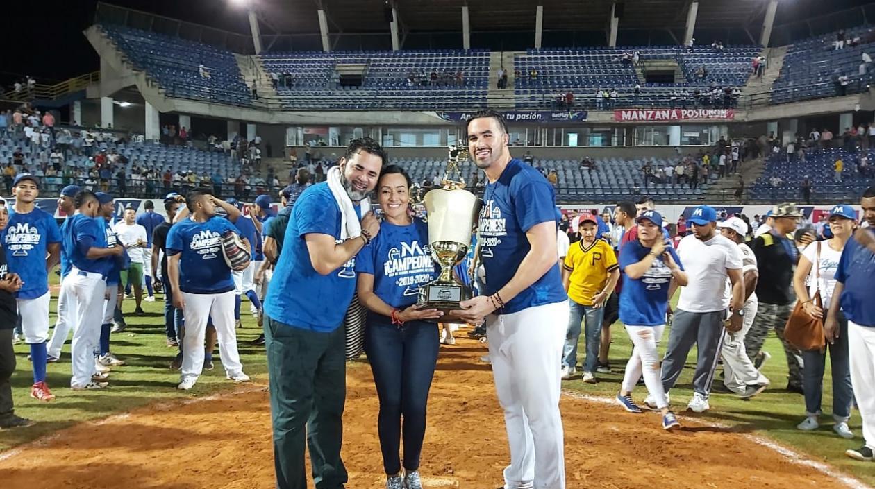 Ozzie Guillén celebra el título de campeón, mientras su esposa Ibis Cárdenas y su hijo Ozney Guillén levantan el trofeo. 
