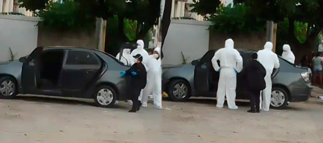 Autoridades inspeccionan el vehículo donde asesinaron a Juan Manuel Mendoza.