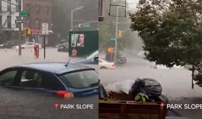 Vehículos a punto de ser tapados por las aguas en Nueva York en plena lluvia